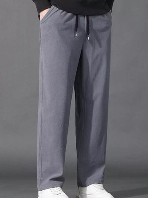 Light gray corduroy joggers with drawstring waist and pockets.