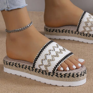 White embroidered platform espadrille slides with zigzag pattern and woven espadrille sole.
