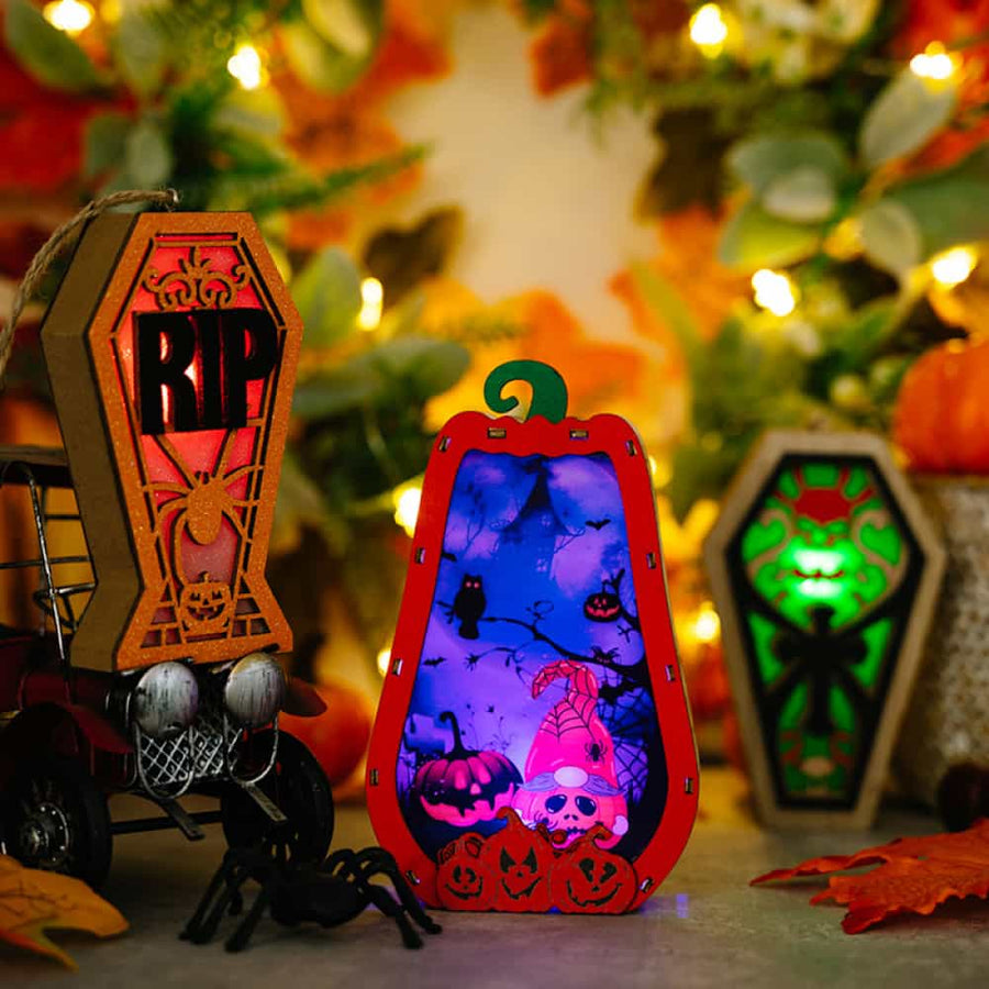 Spooky Silhouette Lantern Trio ornaments with RIP coffin, pumpkin, and gnome designs.