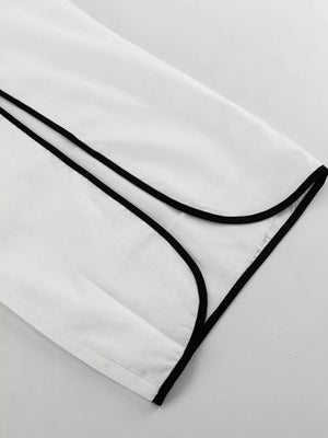 White shirt with black piping detail on collar and cuff