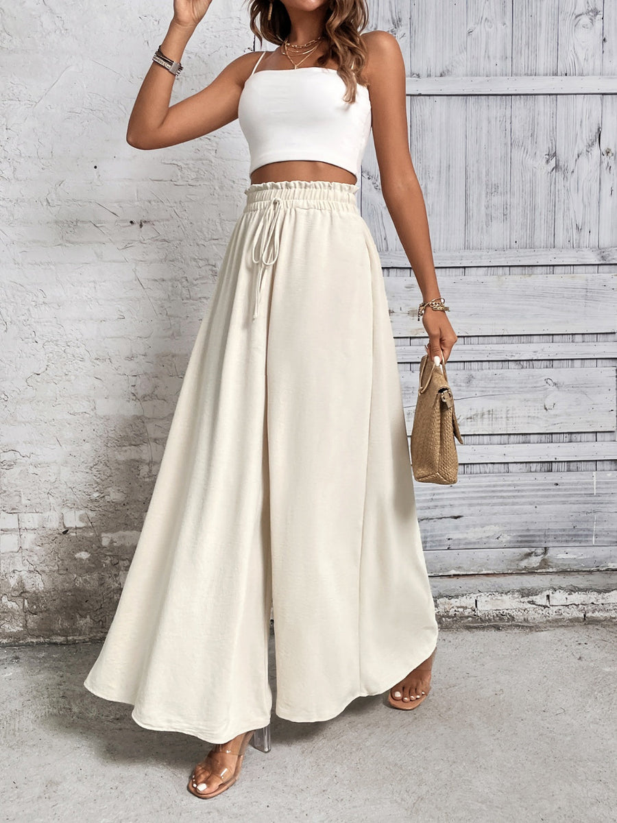 Beige ruffled waistline palazzo trousers with a drawstring waist and wide legs.