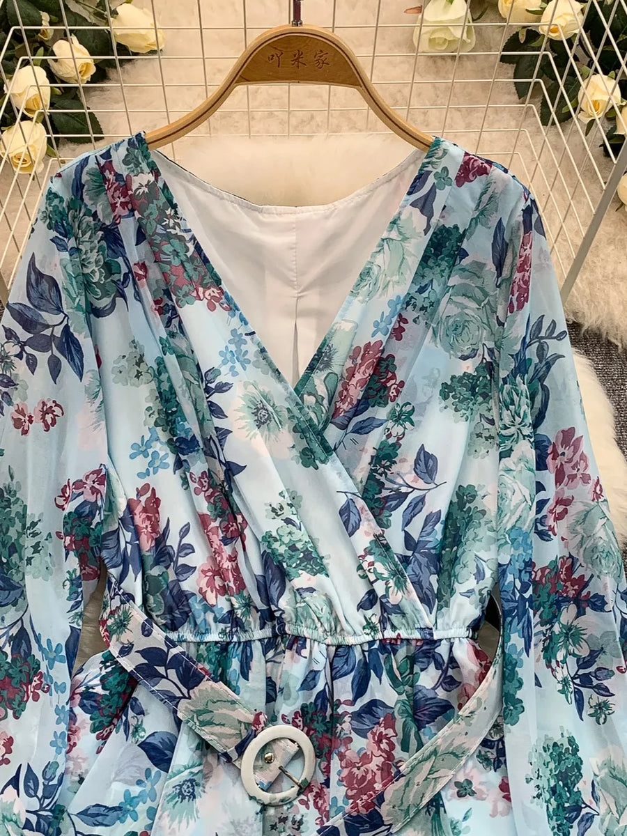 Light blue floral wrap mini dress with V-neck, cinched waist, and belt.