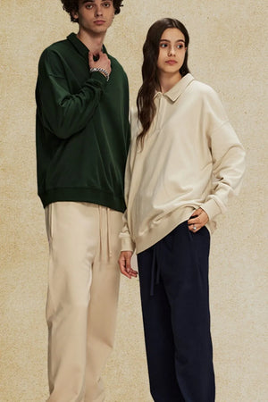 Oversized polo sweatshirt in dark green and tan with collar and quarter zip.