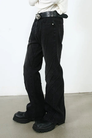 Dark denim flare jeans with chevron seam detailing and a slight flare at the leg.