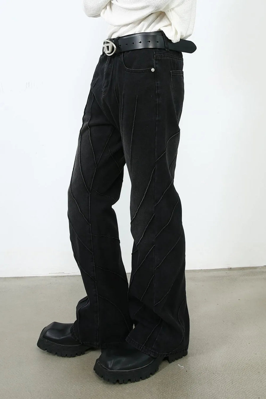 Dark denim flare jeans with chevron seam detailing and a slight flare at the leg.