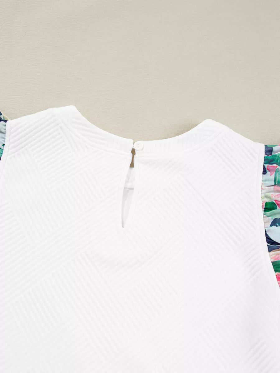 White geometric knit top with floral ruffled sleeves and button back closure.