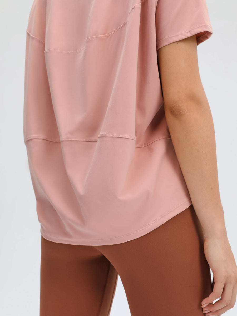 Relaxed fit tee in dusty rose with short sleeves and a curved hem.
