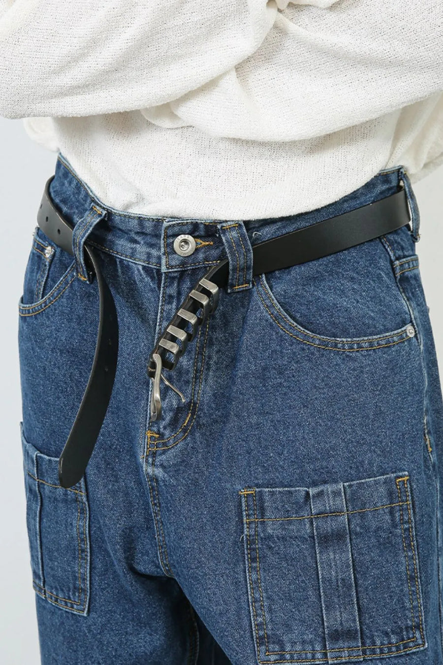 Medium wash denim wide leg cargo pants with buckle pocket detail.