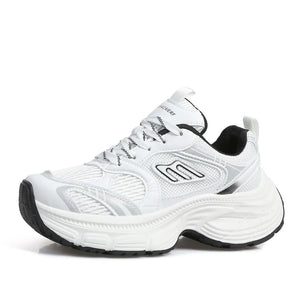 White chunky retro runner sneakers with black and silver accents and a thick sole.
