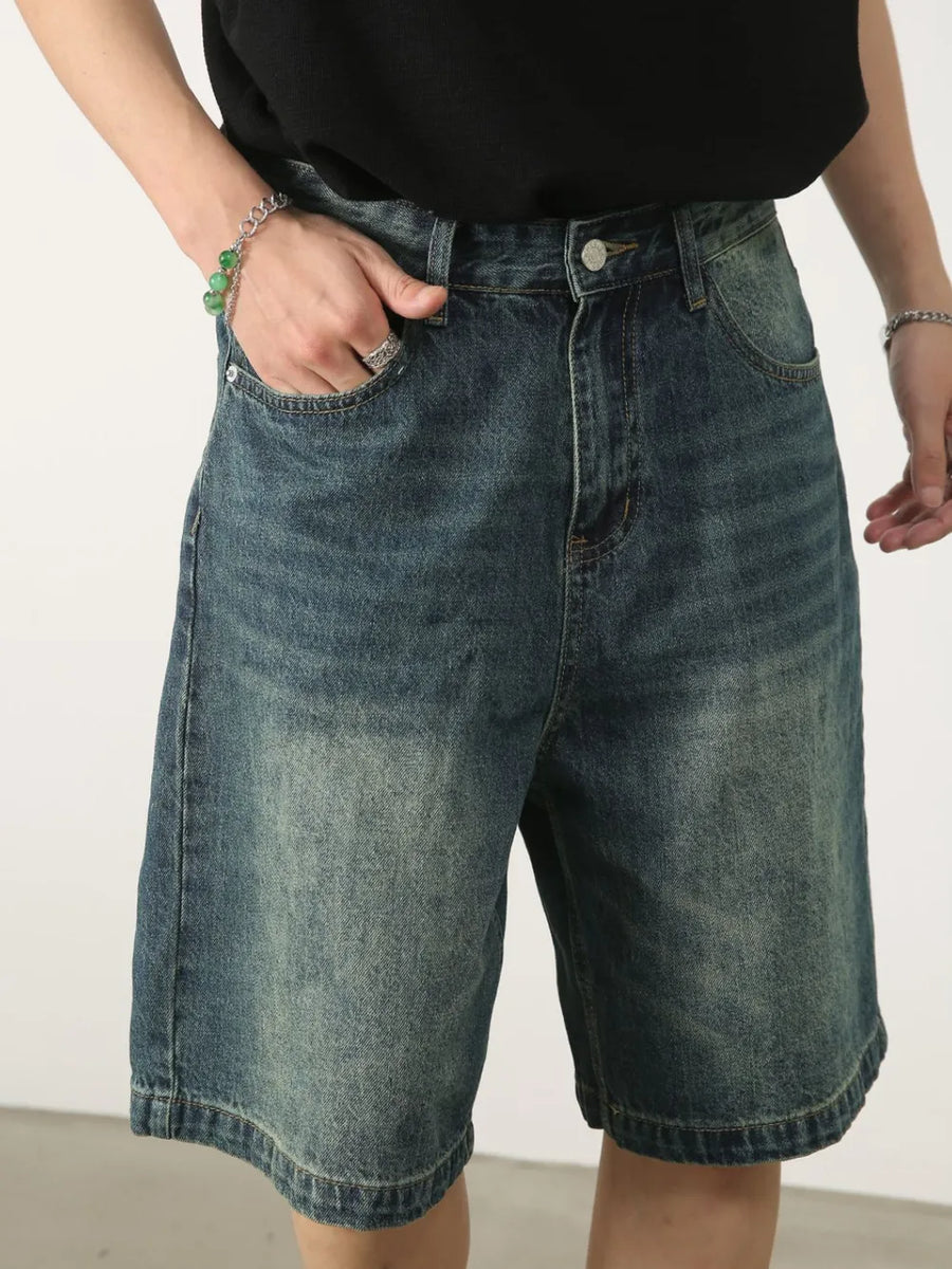 Baggy denim bermuda shorts in light blue with washed effect and button closure.