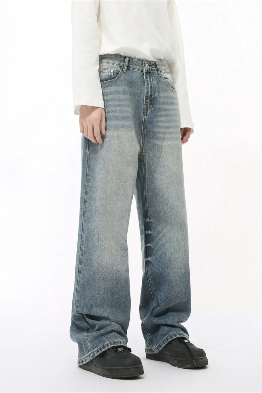 Oversized baggy wash denim trousers in medium blue with a relaxed fit and wide leg.