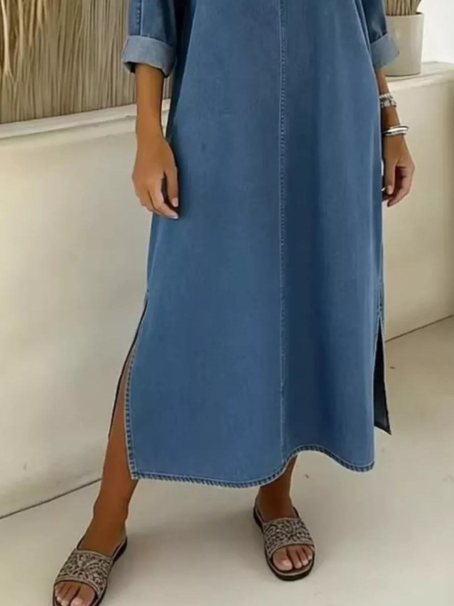 Light blue denim midi dress with V-neck, cuffed sleeves, and side slit.