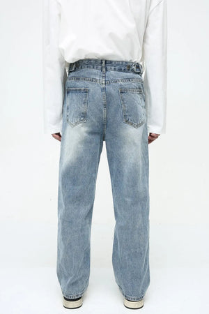 Vintage wash relaxed fit denim jeans in medium blue with button fly and adjustable waist tabs.
