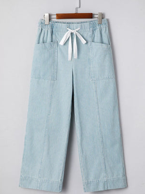Light blue striped mid rise drawstring jeans with wide legs and front pockets.
