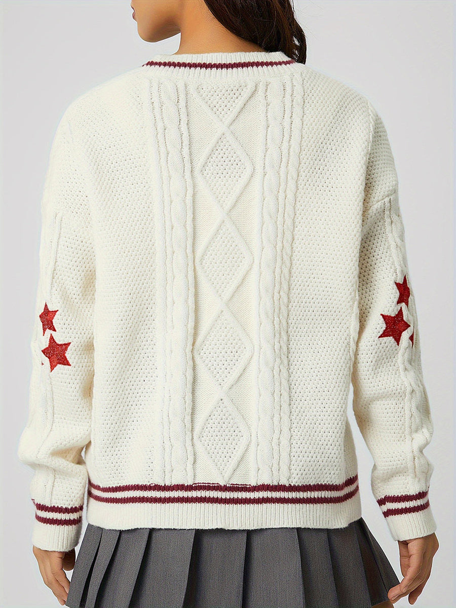 White cable knit cardigan with red stars and striped trim.