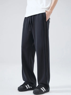 Black relaxed fit drawstring casual pants with double stripe detail.