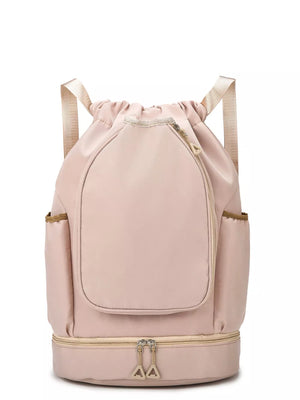 Blush pink drawstring duffel bag with front zip pocket and bottom zip compartment.