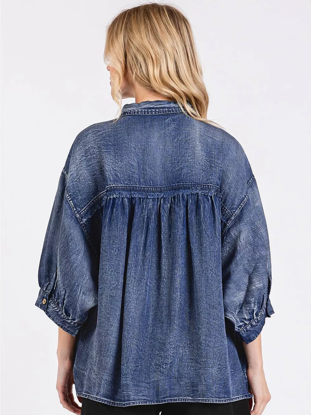 65% cotton, 35% polyester Care instructions: Machine wash cold button-up shirt in denim blue with loose silhouette