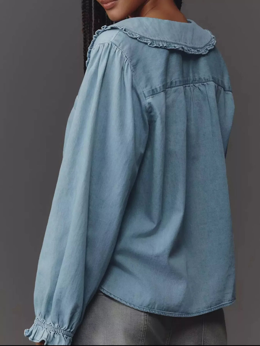 Blue denim shirt with ruffled Peter Pan collar and puff sleeves.