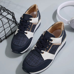 Dark blue lace-up sneakers with white and metallic gold accents and textured panels.