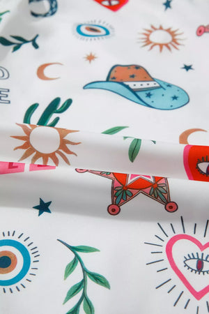 White polyester mini dress with cacti, cowboy hats, suns, moons, and hearts print.