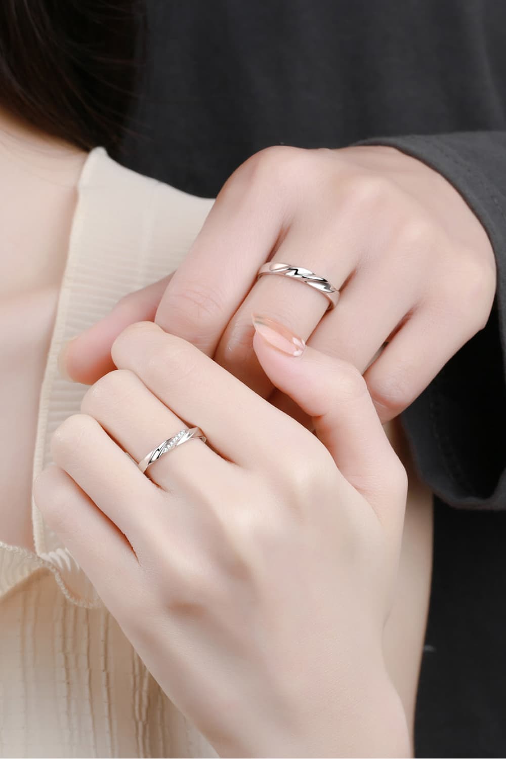 Twisted embrace silver ring set in 925 sterling silver, one with small diamonds.