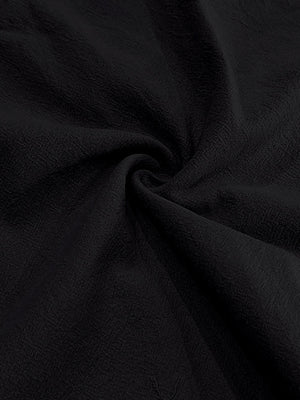 Black linen fabric with a textured weave and soft drape.