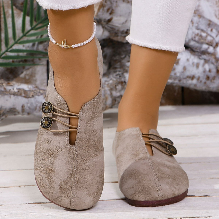Chic round-toe casual flats in light brown with decorative buttons and elastic laces.