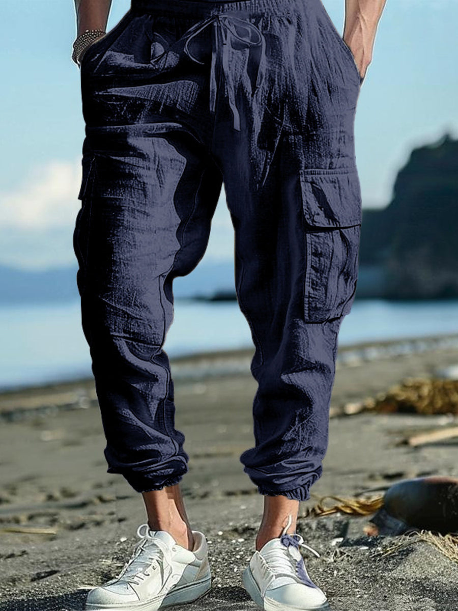 Navy blue cargo pants with drawstring detail and elastic cuffs.