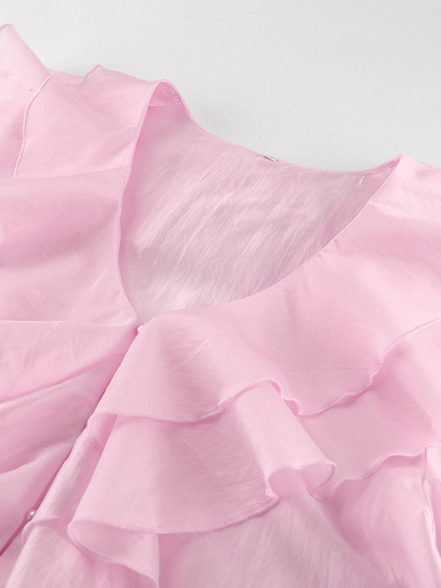 Pink ruffle trim long sleeve blouse with V-neckline and sheer fabric.