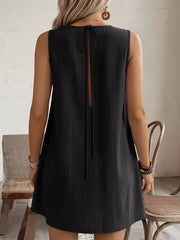 Black sleeveless dress with tie-back detail and pockets