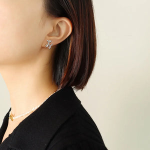 Silver balloon dog sculptural stud earrings on ear