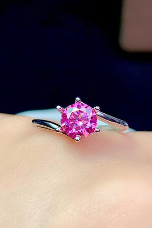 Radiant pink moissanite solitaire ring with a six-prong setting on a silver band.