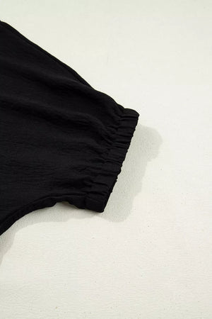 Black polyester tunic with cinched elastic cuff detail on sleeve