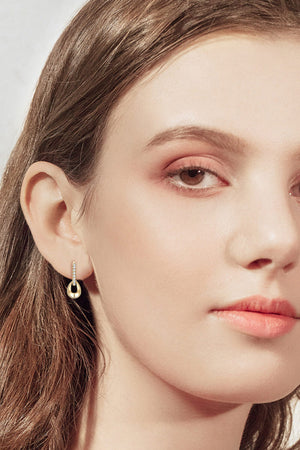 Gold teardrop sterling silver hoop earrings with pavé detail.
