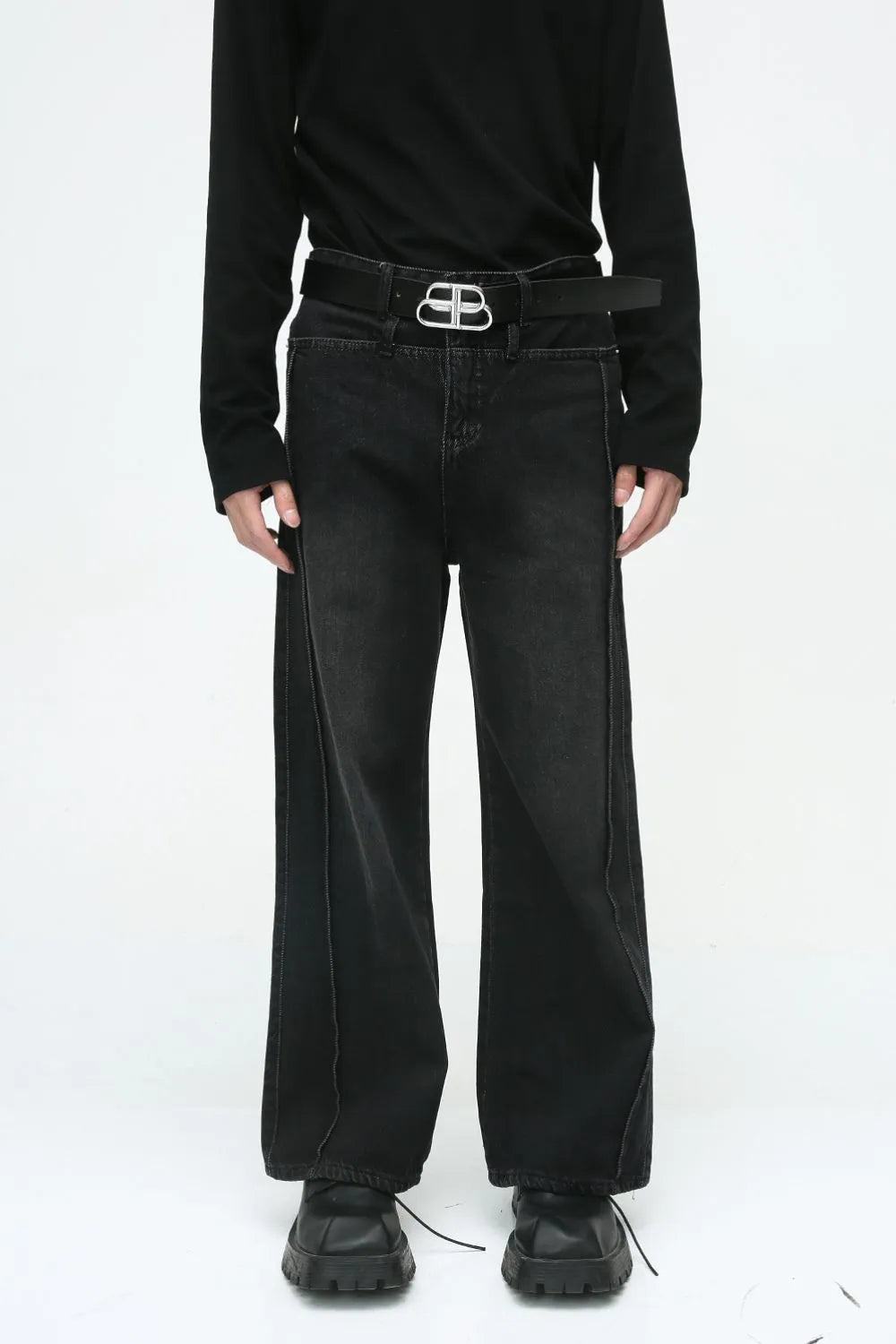 Dark wash wide-leg denim jeans with vertical seams and a relaxed fit.