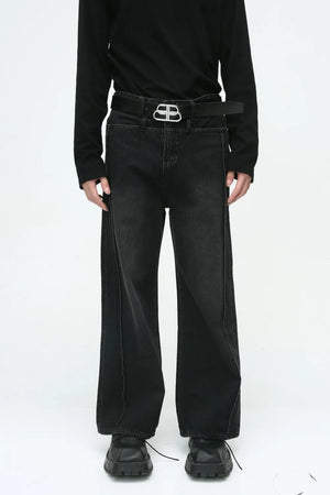 Dark wash wide-leg denim jeans with vertical seams and a relaxed fit.
