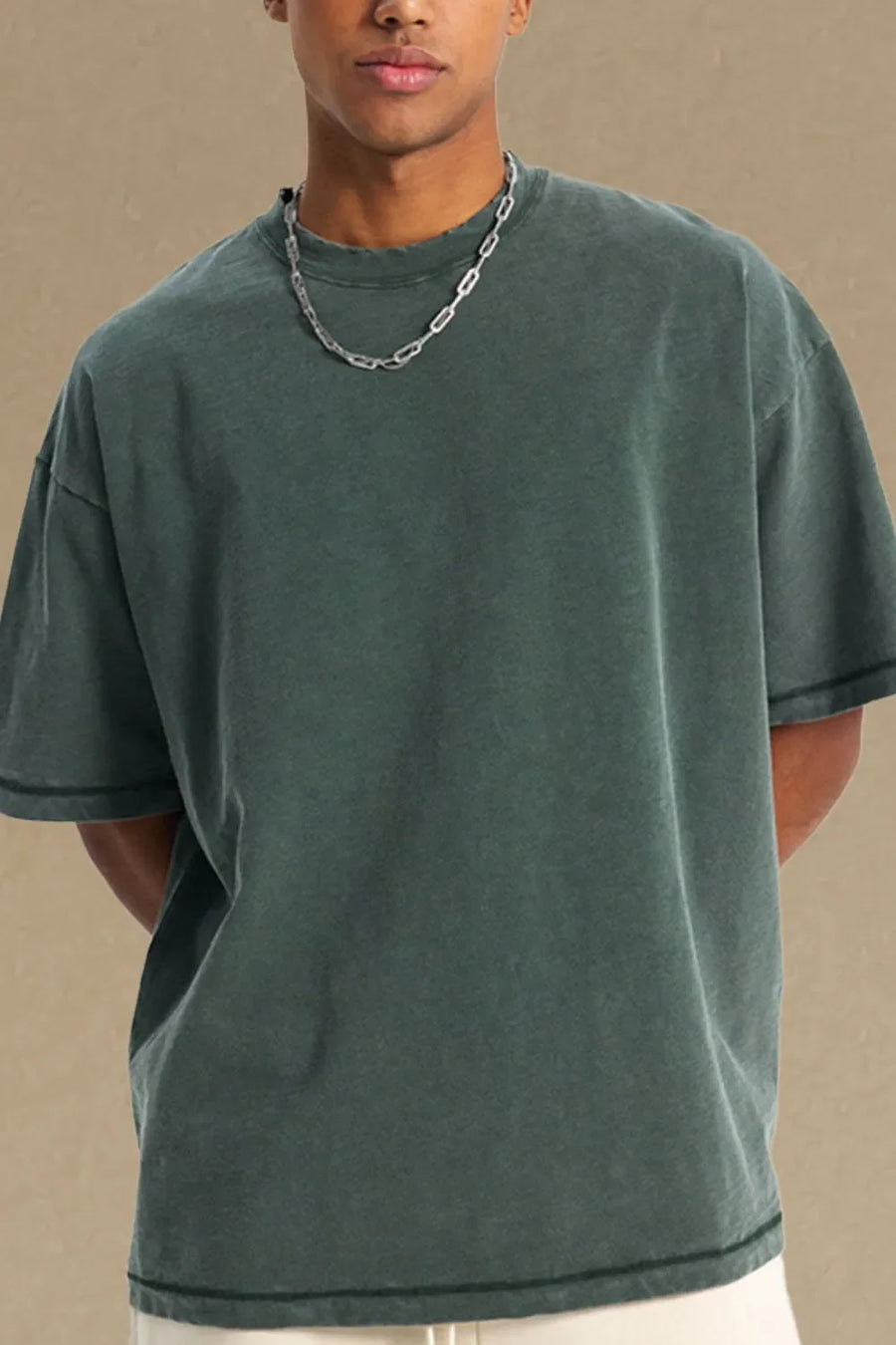 Men's dark green relaxed fit crewneck t-shirt with short sleeves and distressed neckline.