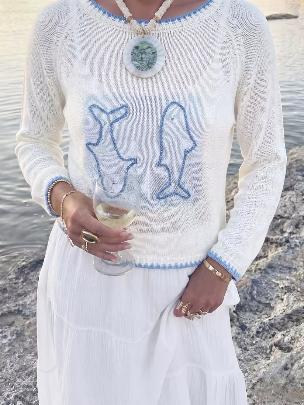 White pullover sweater featuring contrast trim and graphic