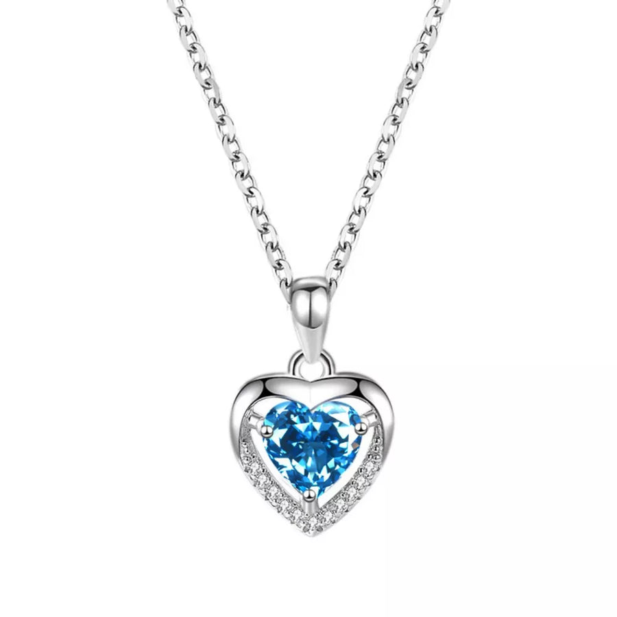 Elegant heart pendant necklace in pastel blue with a delicate silver chain and cubic zirconia accents.