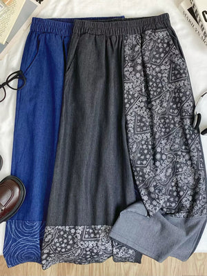 Printed comfort jeans in blue and black with drawstring waist and paisley pattern detail.