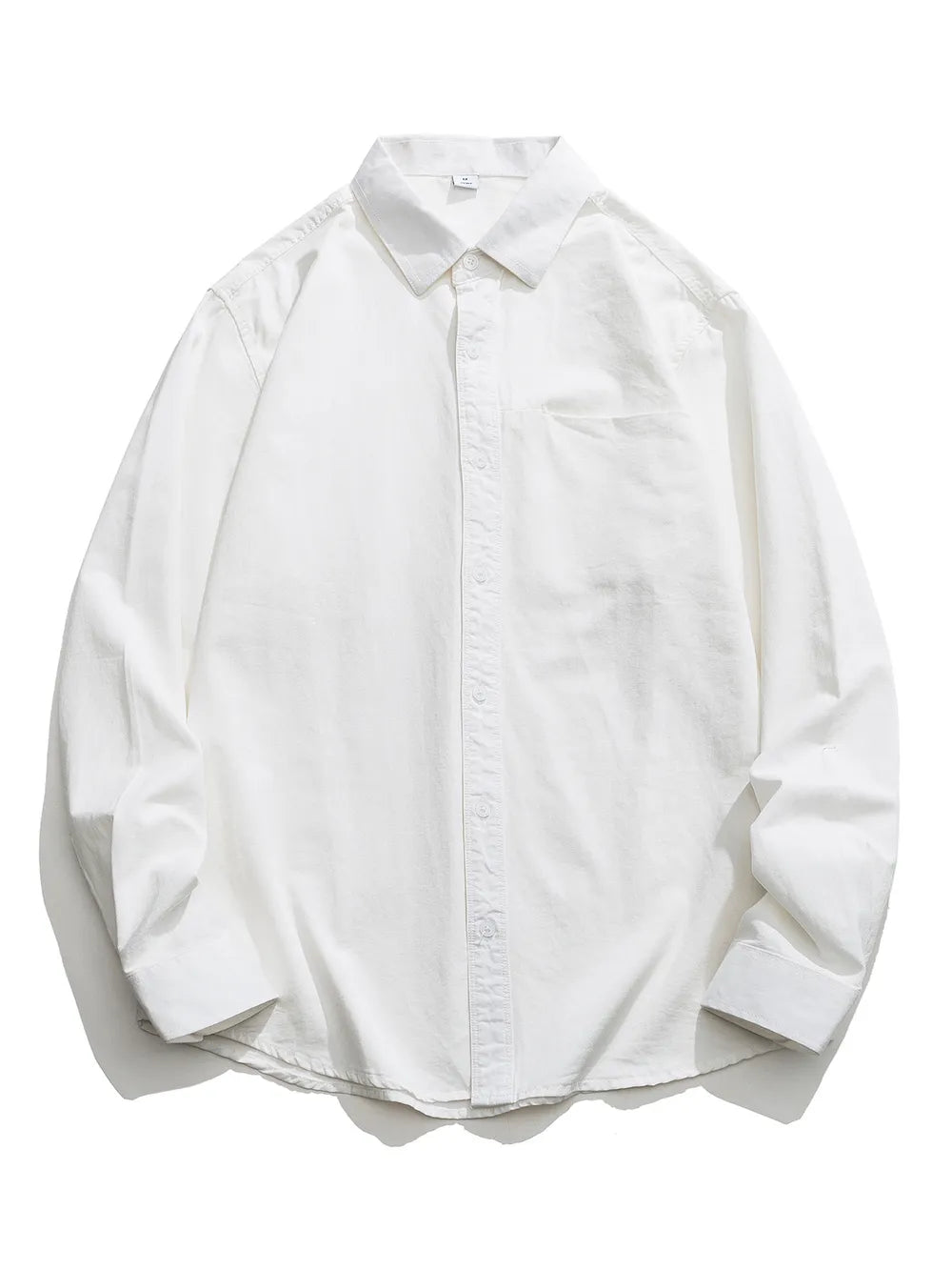 White cotton button-down shirt with long sleeves and a chest pocket.