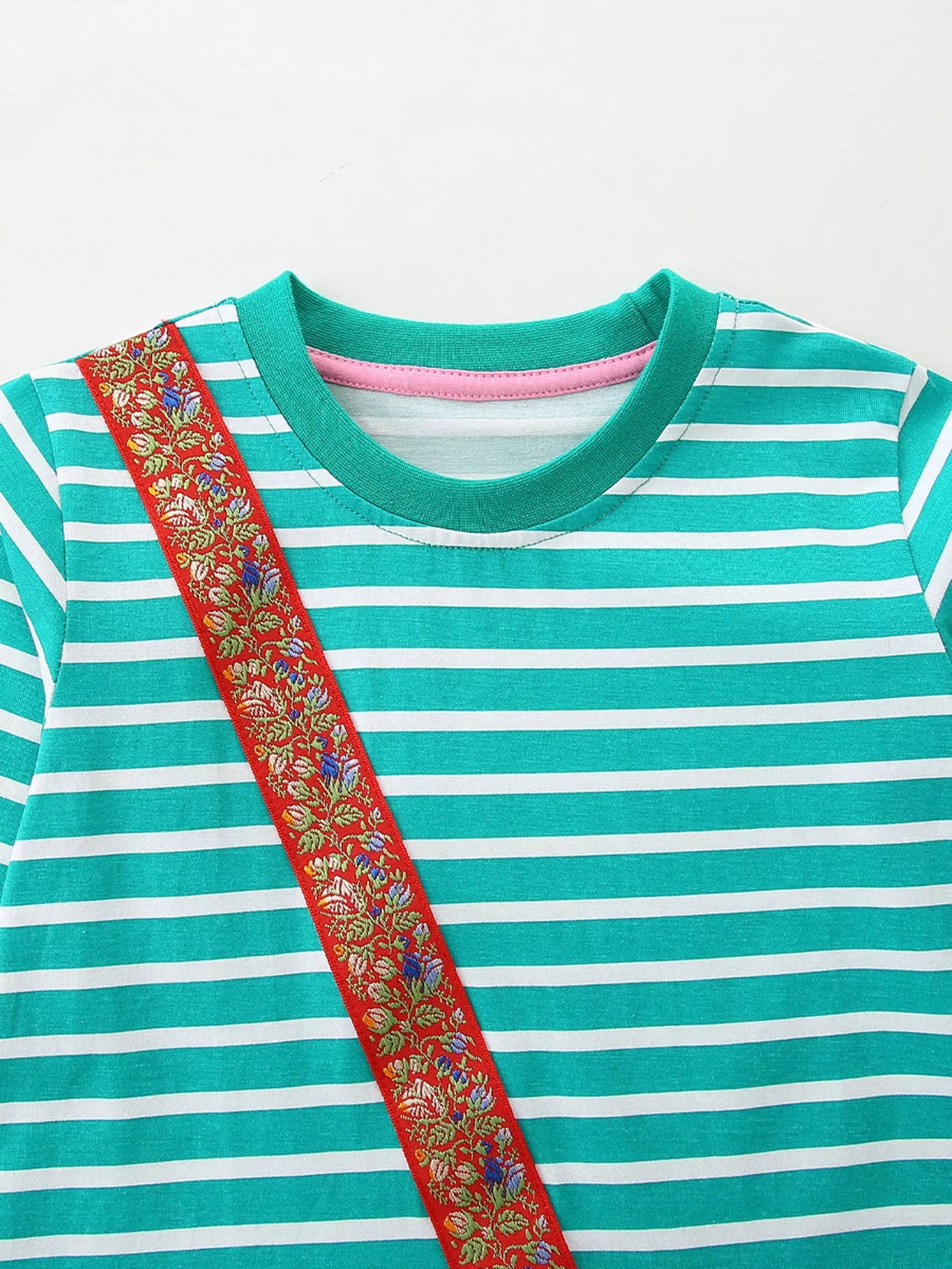Turquoise and white striped cotton dress with a red embroidered floral ribbon detail.