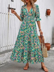 Vibrant V-neck flounce sleeve maxi dress with abstract print, tiered skirt, and lace trim.
