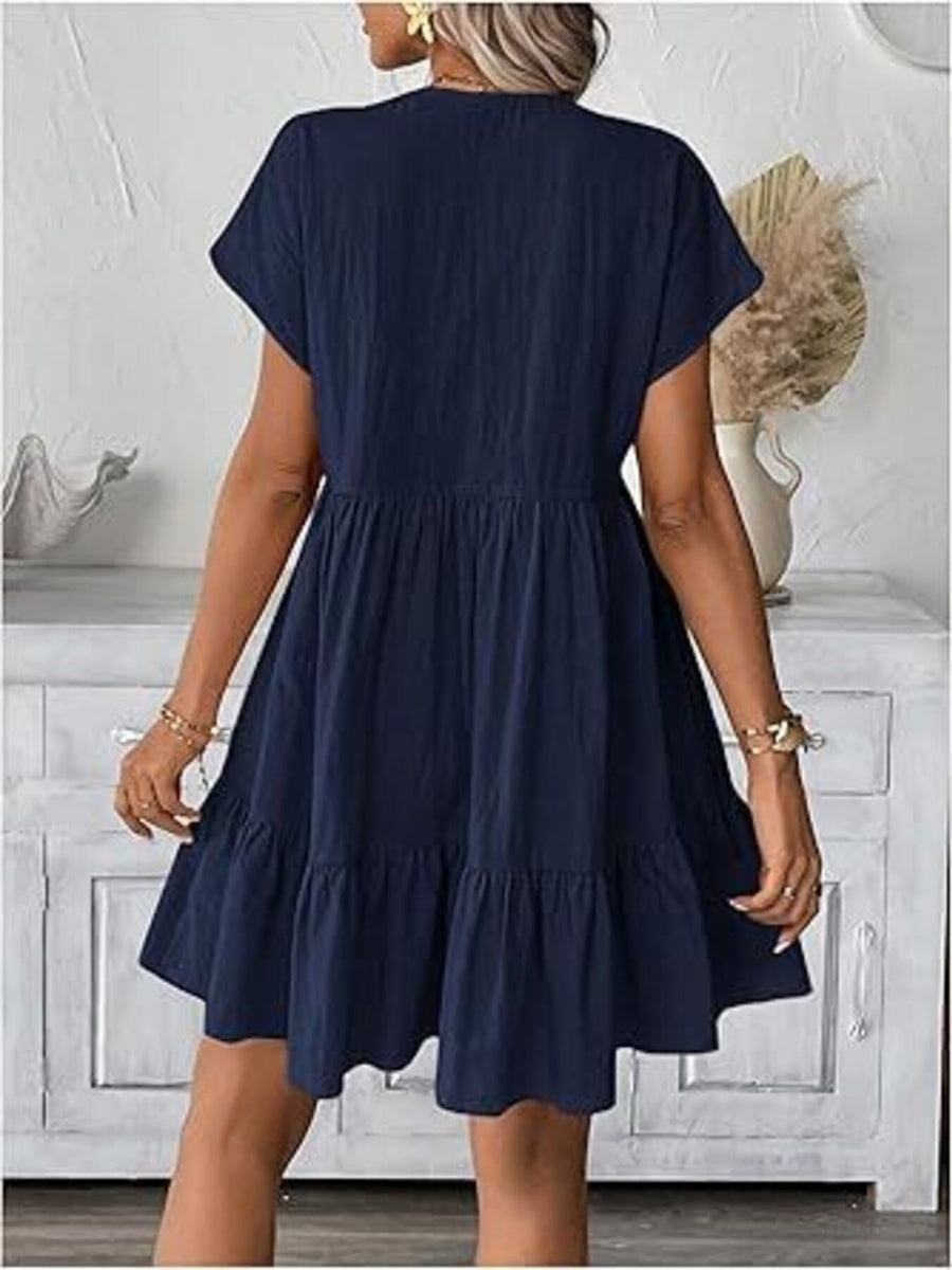 Navy ruffled mini dress with short sleeves and V-neck, tiered skirt detail.