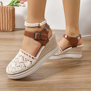 Beige crochet and leather wedge ankle strap sandals with a pearl ankle bracelet.