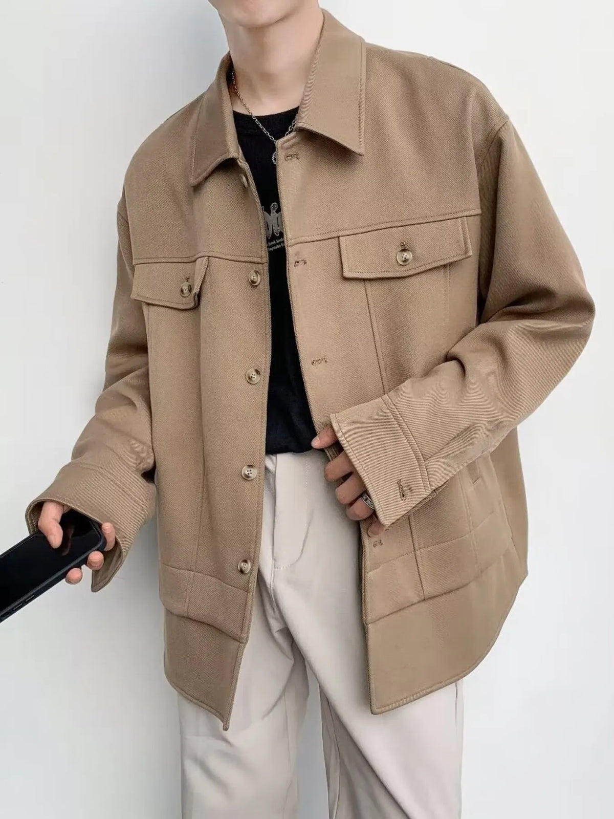 Oversized khaki button-down jacket with chest pockets and button cuffs