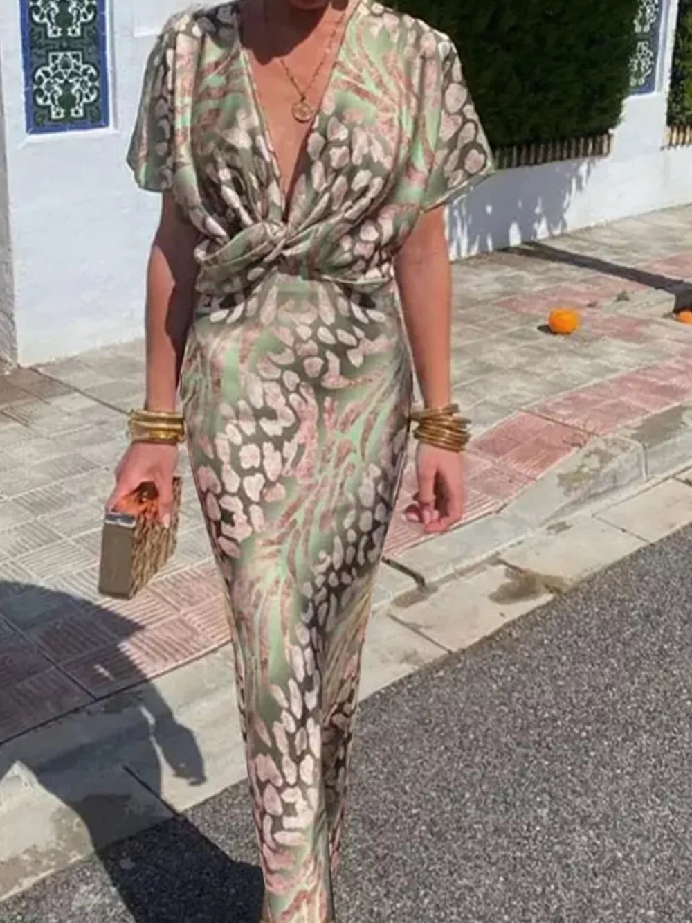 Twist-front animal print maxi dress with deep V-neck and short sleeves.
