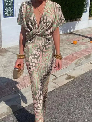 Twist-front animal print maxi dress with deep V-neck and short sleeves.