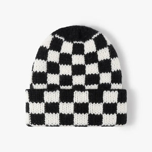 Checkerboard knit beanie in black and white with a cuffed brim.